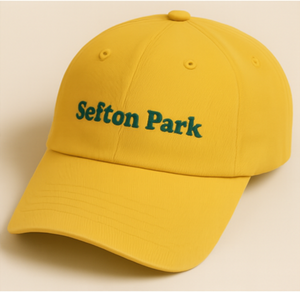 Yellow cap with 'Sefton Park' text on a beige background